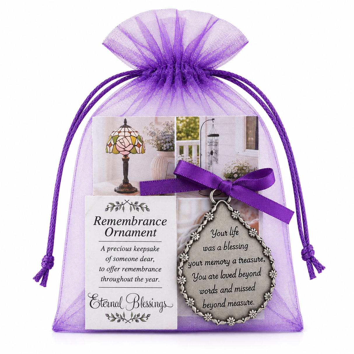 A sheer purple organza gift bag with drawstrings holds a remembrance ornament card set, tied with a satin ribbon. The front shows a decorative memorial Christmas ornament and printed memorial text against a clean white background.