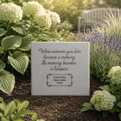 A stone memorial plaque with an inscription that reads, "When someone you love becomes a memory, the memory becomes a treasure." Surrounded by green plants and flowers in a garden.
